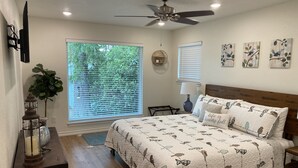 A bedroom with a bed, a ceiling fan, and two windows with blinds. - Waterfront 5/3 roomy home, constant level Lake LBJ, jet ski ramp & covered porch (Kingsland)