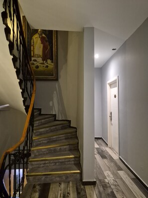 A staircase with a handrail, a painting above it, and a door at the end. - Miss City Hotel Taksim (Istanbul)