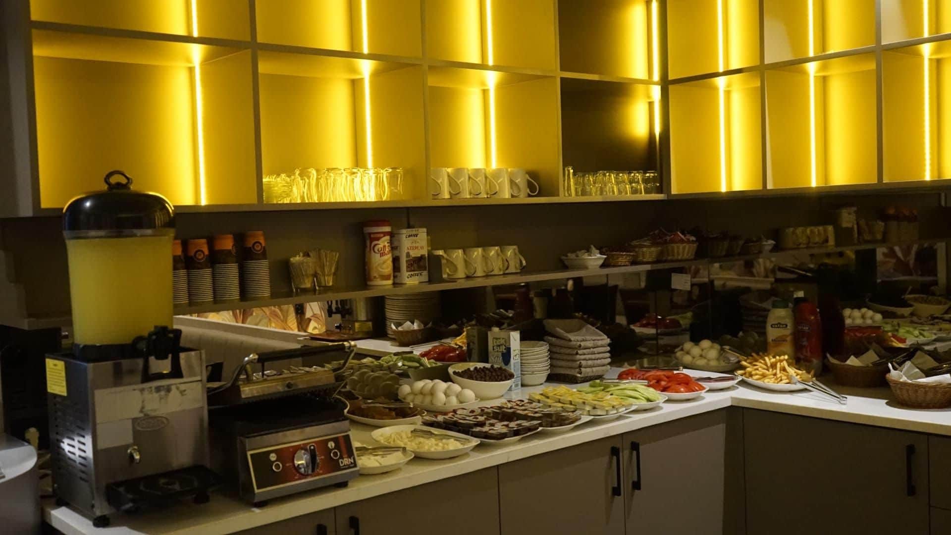 A buffet area with various food items and a coffee station.
