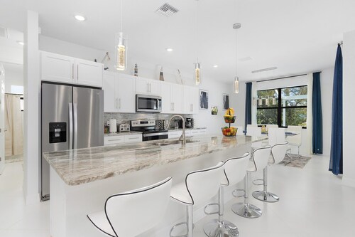 Modern 4BD/3BH Waterfront Home with Heated Pool and Golf Access and EV Charger