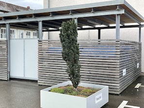Guests can enjoy a tidy outdoor space with a covered area and a designated visitor area.