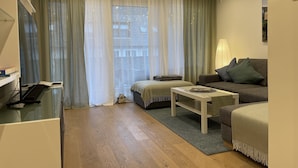A modern living room with a sofa, a coffee table, and a TV stand. - Shopping, vacation or business - you've finally come to the right place (Metzingen)