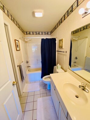 Combined shower/bathtub, towels, soap, toilet paper
