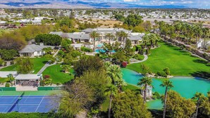 A large estate with a swimming pool, tennis courts, and a golf course. - Chateau Dumont - 15 bedroom mansion (Rancho Mirage)