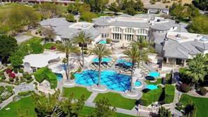 A large estate with a swimming pool, palm trees, and a well-maintained lawn. - Chateau Dumont - 15 bedroom mansion (Rancho Mirage)