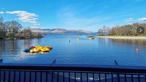 A lake with boats and a dock. - Riva Boutique Hotel & Restaurant (Helensburgh)