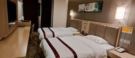 A hotel room with two beds, a desk, a TV, and a painting on the wall.