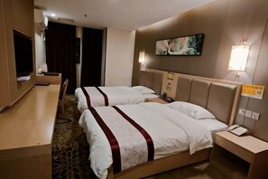 A hotel room with two beds, a desk, a TV, and a painting on the wall.