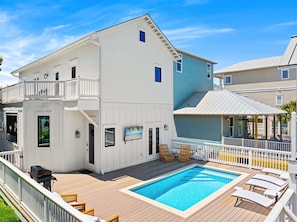A two-story house with a swimming pool, deck chairs, and a covered patio area. - Crystal Oasis with EV Charger, Pool, Beach Chair Setup, and Steps From Beach (Destin)