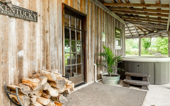 A rustic wooden building with a sign reading "Welcome to Our Old Kentucky Home Sweet Home."