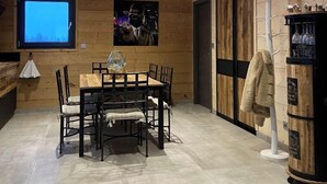 A wooden interior with a dining table, chairs, a TV, and a whiskey barrel. - Chalet "DIANA", at the foot of the ski slopes. Pets allowed  (Gérardmer)