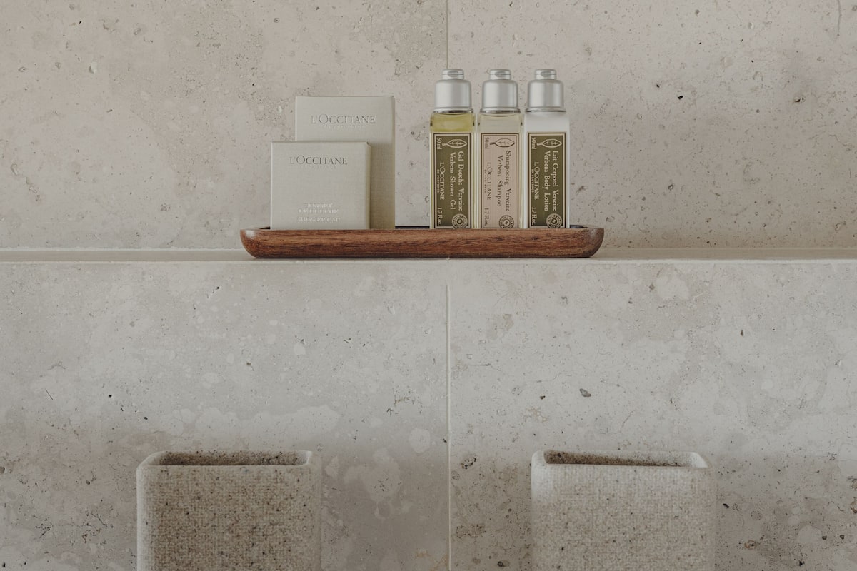 designer toiletries, hair dryer, bathrobes, slippers
