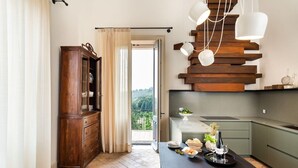 Una cucina moderna con zona pranzo, un armadio in legno e vista su piante.