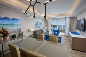 Premium Suite, 1 King Bed with Sofa bed | Living area | 65-inch Smart TV with cable channels, TV