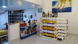 A room with a bookshelf, a painting, and a decorative lantern structure.