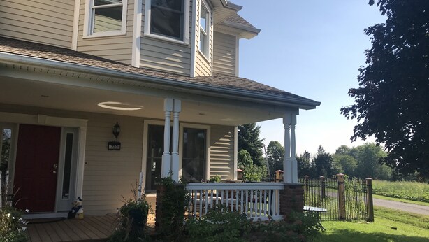 A two-story house with a front porch, a red door, and a mailbox marked with the number 732. - Dicksons Family Suite B&B (Niagara-on-the-Lake)
