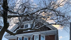 A two-story brick house with a front porch and a staircase leading to the entrance. - The Red Brick Inn - 10 Minute Walk to the Falls (Niagara Falls)