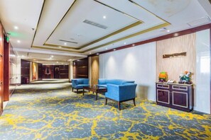 A hotel lobby with a marble floor, seating area, and a reception desk. - The Dynast's Hotel (Foshan)