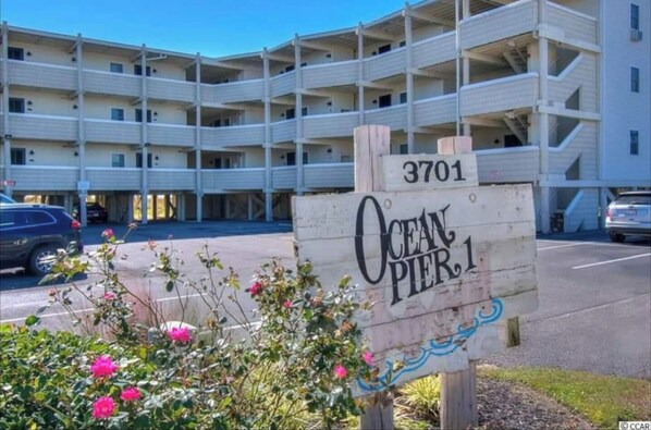 A multi-story building with a sign reading "Ocean Pier 1" and the number "3701".