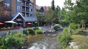 A riverside building with outdoor seating and a view of the river. - Downtown Location walk to Main Street and Gondola from this updated Condo (Breckenridge)