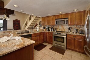 Enjoy cooking in this well-equipped kitchen with an oven, microwave, and refrigerator.