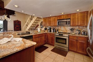 Enjoy cooking in this well-equipped kitchen with an oven, microwave, and refrigerator.
