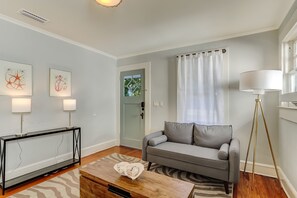 Relax in this stylish living room with a sofa, coffee table, and floor lamp.