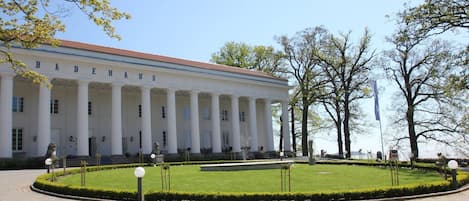 A large, classical building with a symmetrical facade, columns, and a central entrance.