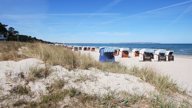 A beach with rows of beach huts and a sandy dune in the foreground. - Quiet location close to the sea, terrace and garden - Ferienhaus Auszeit FeWo 01 - (Middelhagen)