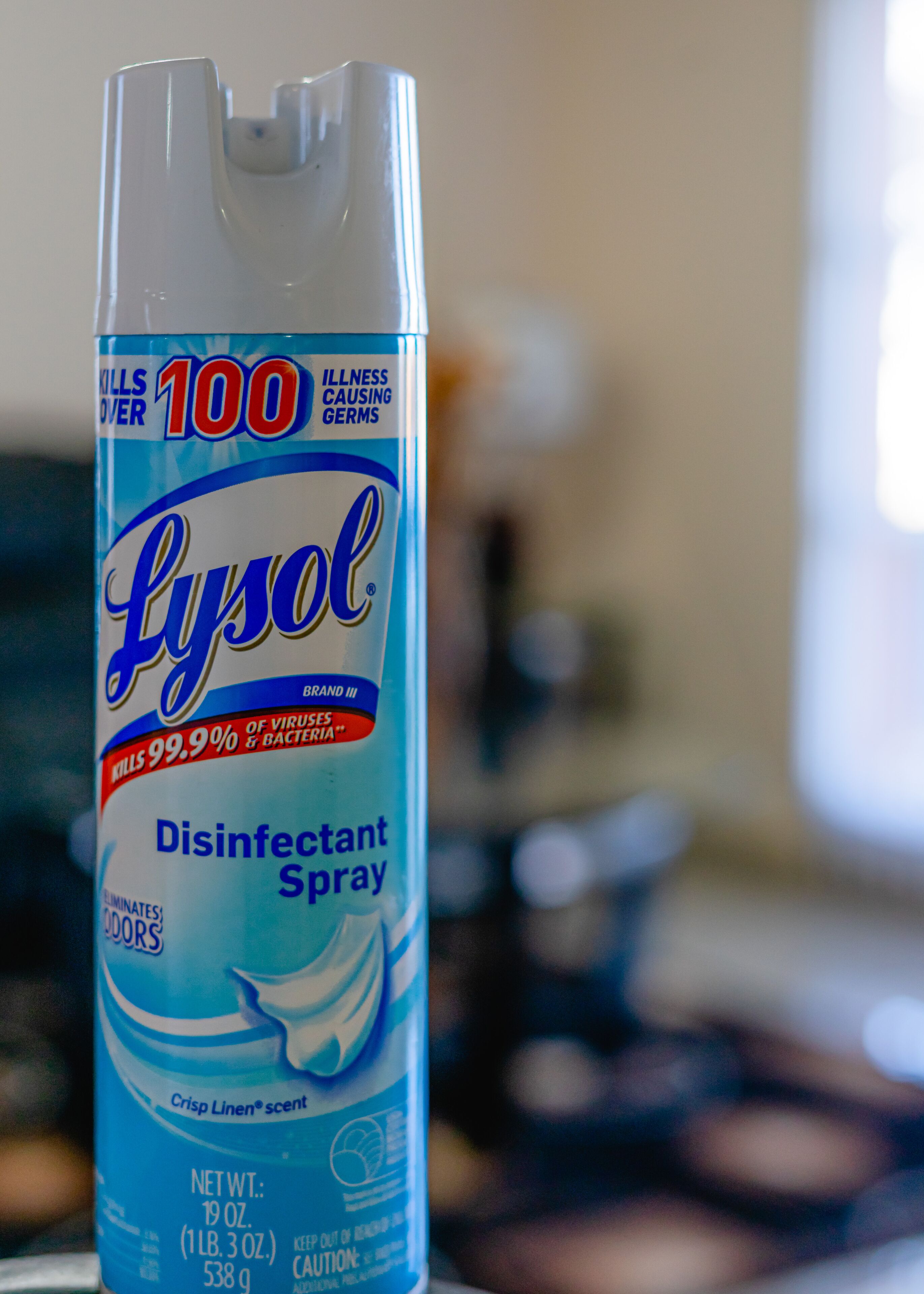 A Lysol disinfectant spray bottle with a label indicating it kills 99.9% of viruses and bacteria.