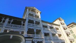 A multi-story building with balconies and arched windows.