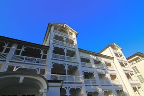 A multi-story building with balconies and arched windows.