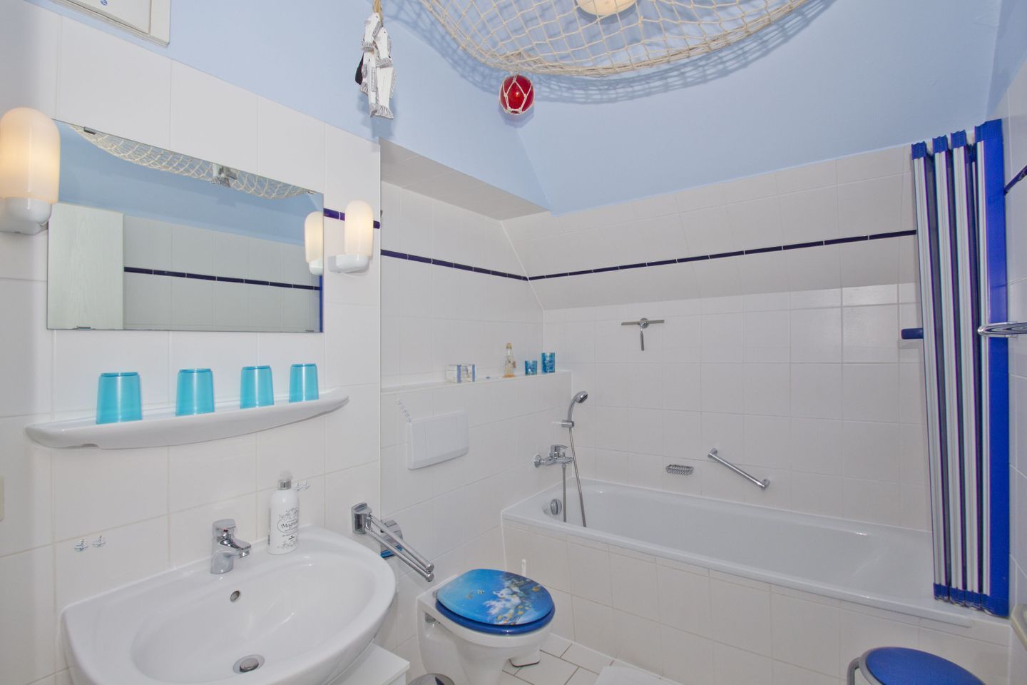 A modern bathroom with a bathtub, a sink, and a toilet.