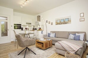 Ein modernes Wohnzimmer mit einer Couch, einem Couchtisch und einem Essbereich.