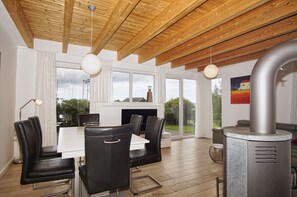 A modern kitchen with a large island, wooden ceiling beams, and a view of the outdoors. - Vacation home close to the harbor with terrace and sea view - Holiday home TimpeTe Starboard (Gager)