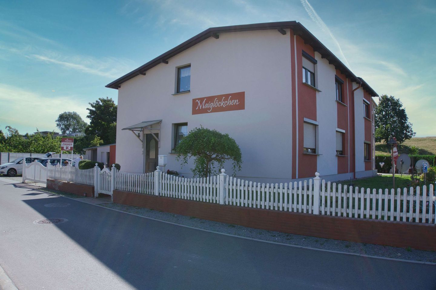 A two-story building with a sign reading "Maiglöckchen" on the front.