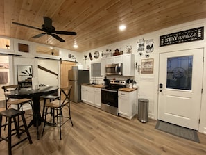 Enjoy cooking and dining in this fully equipped kitchen with a refrigerator, microwave, oven, and sink.
