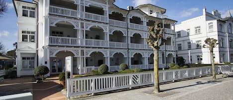 A multi-story building with balconies and a sign reading "Villa Secadler".