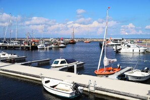 A marina with various boats docked at the piers.