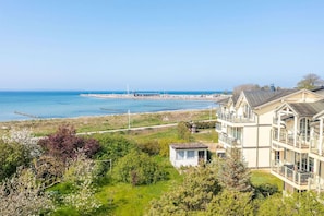 A coastal building with multiple balconies overlooking the sea.