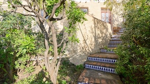 A staircase with blue and white patterned steps leading up to a building with a white balcony. - "Villa María" with Sea View, Garden, Balcony & Wi-Fi (Almunecar)
