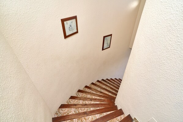 A staircase with wooden steps and two framed pictures on the wall. - "Villa María" with Sea View, Garden, Balcony & Wi-Fi (Almunecar)