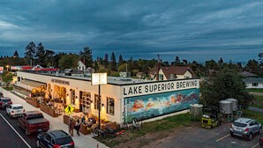 A brewery with outdoor seating and a mural of a lake. - Lakewalk House, near Lake Superior's North Shore and more! (Permit#PL 20140) (Duluth)