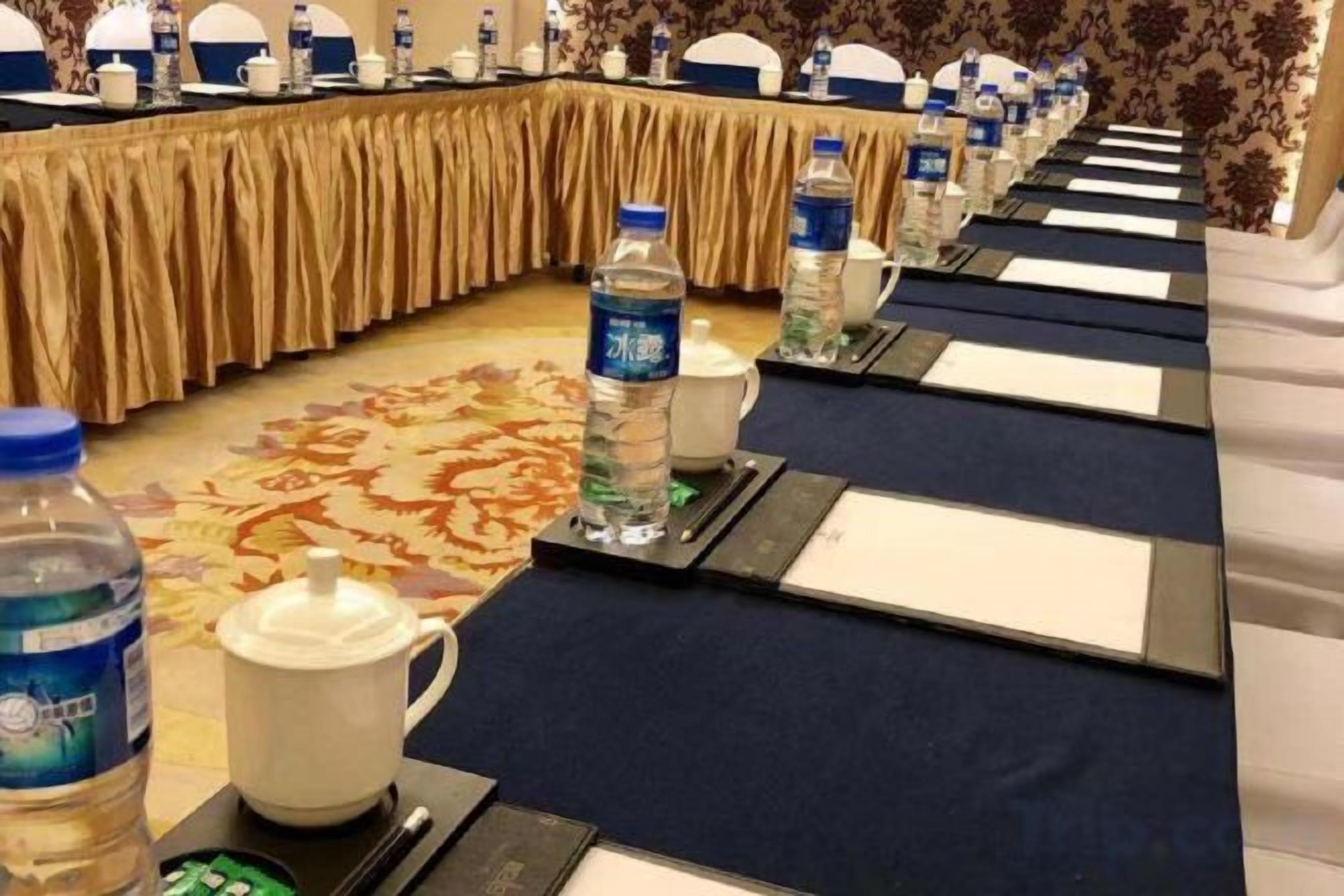 A conference room with a long table, water bottles, and nameplates.