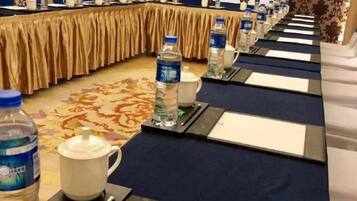 A conference room with a long table, water bottles, and nameplates.