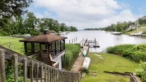 A wooden deck with a gazebo overlooking a river, docks, and boats. - Waterfront Home w Pool, Pier & Parking Mins to Annapolis (Arnold)