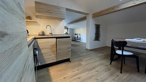 A modern kitchen with wooden cabinetry and a skylight.