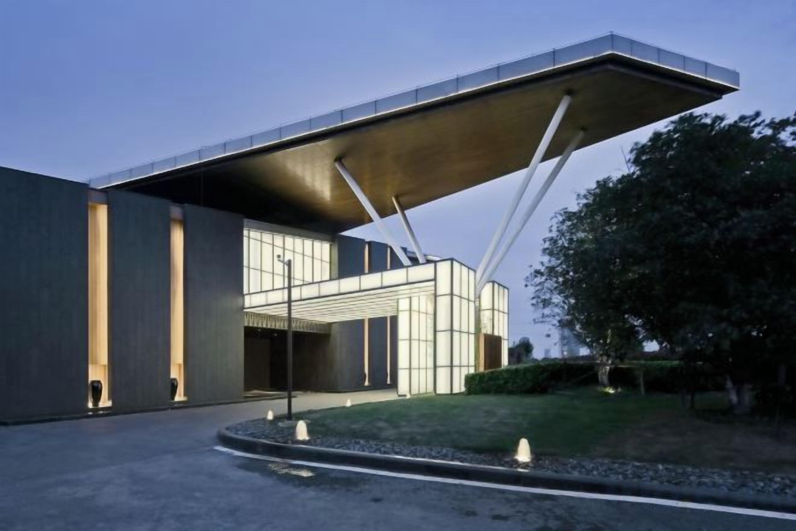 A modern building with a unique cantilevered roof structure.