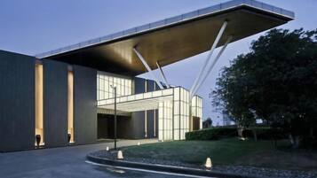 A modern building with a unique cantilevered roof structure.