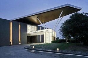 A modern building with a unique cantilevered roof structure. - Arcadia Hotel (Jiangyin)